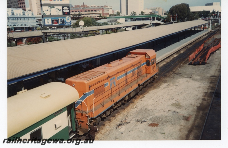 P19265
A class 1504, on passenger train, signal, bracket signals, signal gantry, trackwork, city background, Perth City Station, view from elevated position
