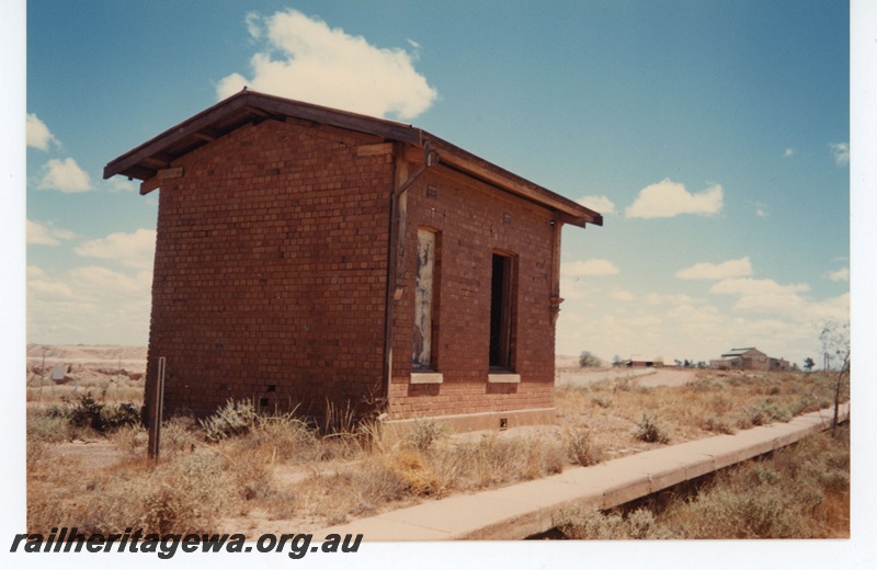 P19285
Abandoned platform and station building, Kamballie, B line, ground level view
