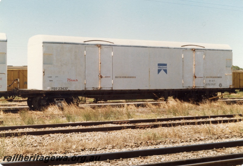 P19360
WBR class 23432 cold storage van, white livery with a blue Westrail logo on the side, refrigeration unit removed, end and side view.
