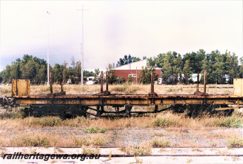 P19481
QNS class 40745-S flat wagon with stanchions end bulkheads, yellow livery, Ex MRWA NB class 339, Robbs, side view
