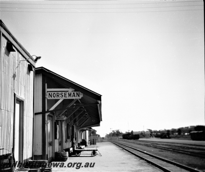 P19521
Station buildings, platform, canopy, luggage trolley, station sign, 