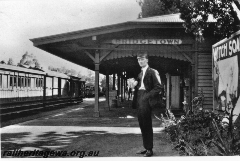 P19612
Bridgetown platform - guard on platform station sign in background. PP line
