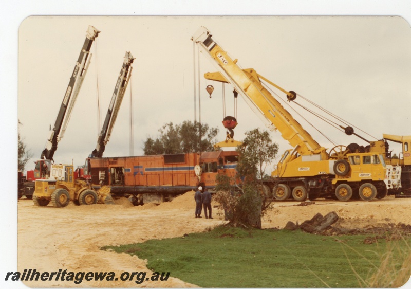 P19621
N class 1880 being lifted by 3 cranes following a level crossing accident with a truck at Wagerup. SWR line.
