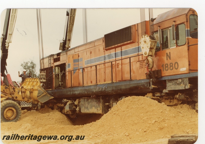 P19624
N class 1880 being lifted by 3 cranes following a level crossing accident with a truck at Wagerup. Close up of lifting anchor points on locomotive. SWR line.
