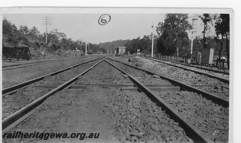 P19657
5 of 5 images of the installation of a double compound (double slip) at Parkerville, ER line. Images 1 & 2 in the sequence are numbered P01052 & P01053. This image, taken at 5pm, shows the finished job, pointwork in position, the line ballasted and ready for service. 
