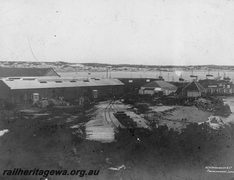 P19673
Fremantle- an early photo of Fremantle jetty showing sailing ships anchored in bay and bond store in foreground. ER line.
