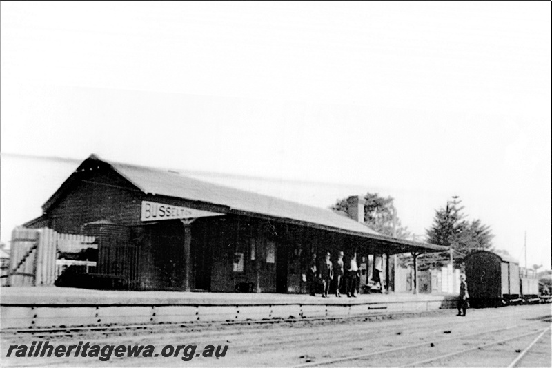 P19703
Station building, station name on the end of the station platform canopy, people on the platform, Busselton, BB line, end and trackside view of the building
