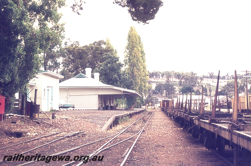 P19730
Platform, station buildings, rake of flat wagons, vans, tracks, Bridgetown, PP line, Easter Saturday
