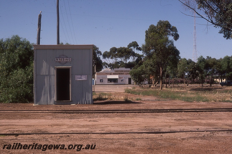 P19744
Out of shed, with nameboard, West Farm Supplies Western Livestock store, tracks, road, Nyabing, KP line
