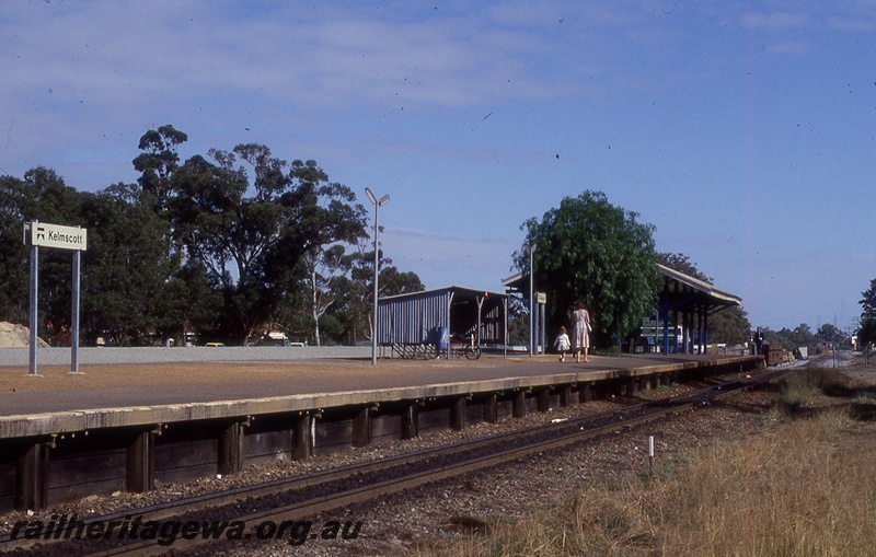 P19786
Platform, shelters, bicycle rack, mother and child, station nameboards, track, Kelmscott, SWR line
