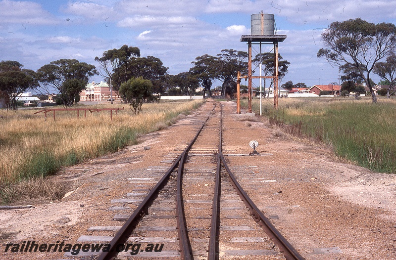 P19823
Water tower, water column, points, point lever, town buildings, Gnowangerup, TO line, view along tracks towards town
