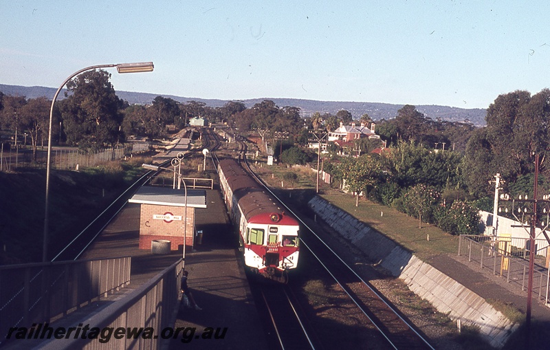 P19836
ADG class railcar leading a DMU set, standing at station, platform, station shelter, pedestrian ramp, station lamps, tracks, Success Hill, ER line, view from overhead footbridge
