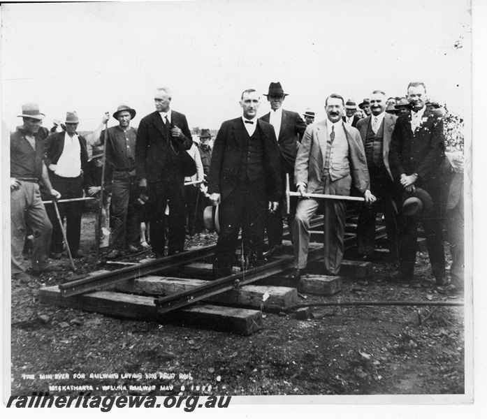 P19868
Crowd of onlookers watching the Minister for Railways laying the first rails of the Meekatharra to Wiluna Railway, NR line
