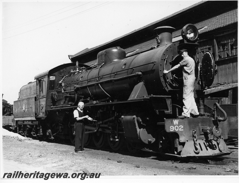 P20007
W class 902,under maintenance, one worker with oil can, another worker in front of open firebox door, shed, East Perth loco depot, ER line, side and front view
