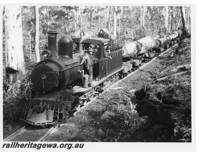 P20024
State Saw Mills loco No 6, with extended smokebox acquired whilst working for WA Manganese Co on their Meekatharra to Horseshoe line about 1932, on a karri log rake, crew, Treen Brook near Pemberton, front and side view
