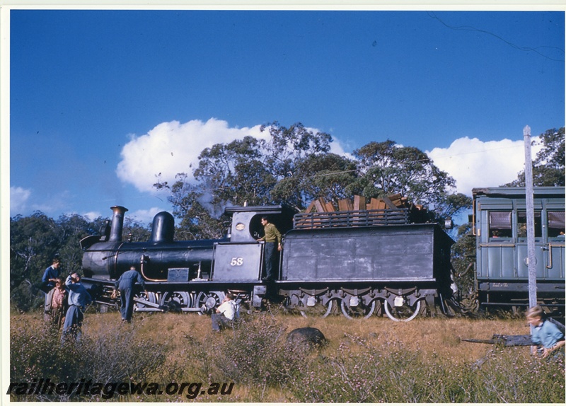 P20031
Millars G class type loco, No 58, on ARHS tour train, stopped in bush setting, passengers stretching their legs, side view from track level
