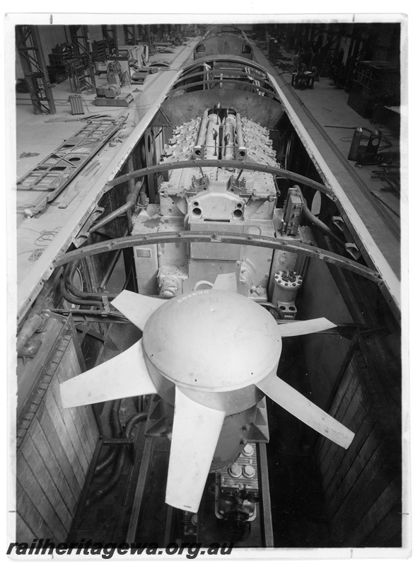 P20061
Diesel loco with roof removed, showing internal machinery including fan and generator from above, interior view from elevated position
