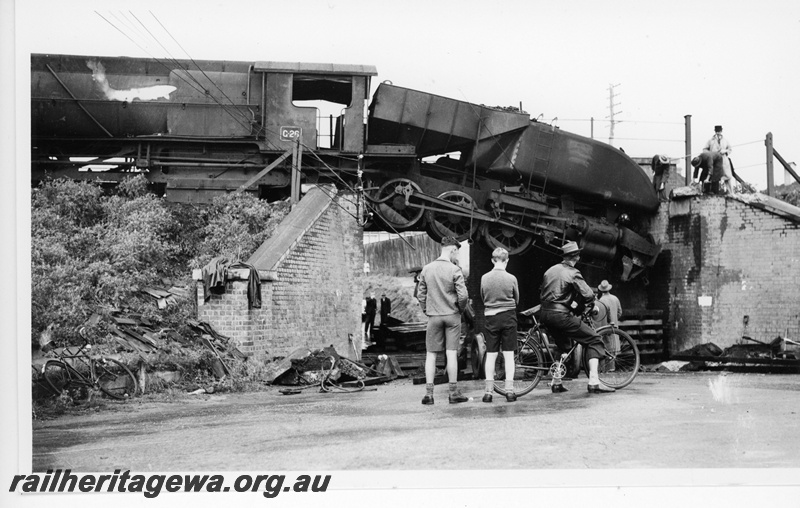 P20077
ASG class 26, derailed at subway, tender and rear drivers suspended above roadway, onlookers, Claremont, ER line
