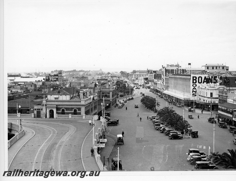 P20084
Perth city railway station building, horseshoe bridge, Wellington Street, cars, palm trees, shops, pedestrians, 