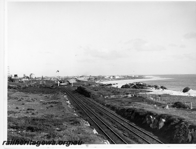 P20085
View of Leighton, looking towards Fremantle, tracks, signals, water tank, industrial buildings, oil tanks, beach, ocean 
