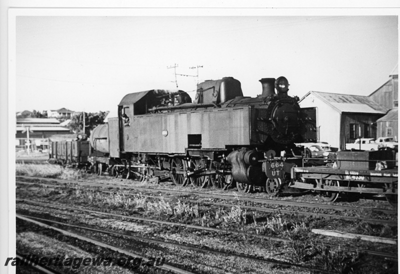 P20095
UT class 664, shunter's float, wagon, tanker wagon, level crossing, sheds, cars parked, Geraldton, NR line, side and front view
