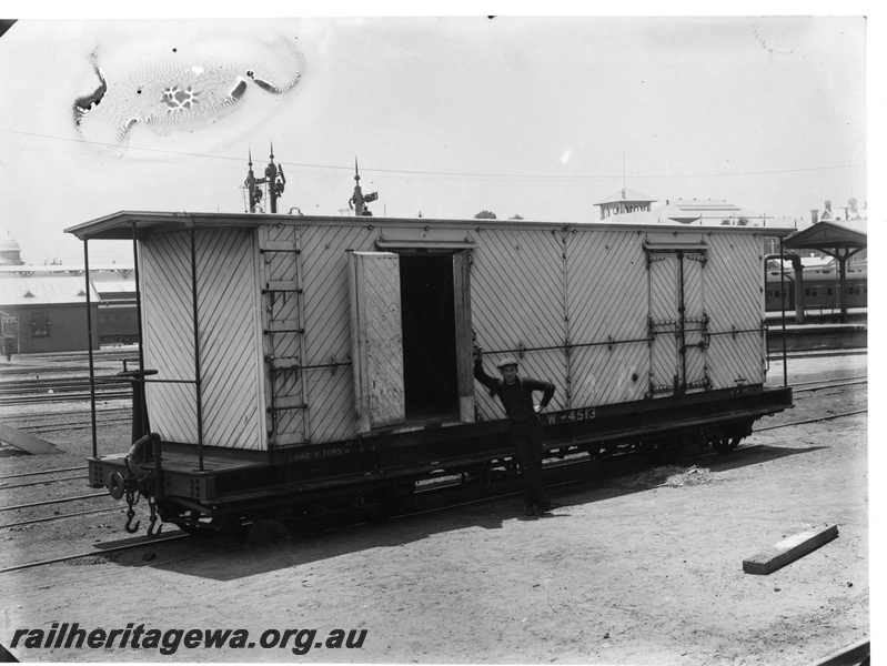 P20142
W class 4513 bogie cold storage van, white livery, diagonal planked sides and ends, brake standard on the end platform, semaphore signals (top only), water column, platform and canopy (part only), worker, Perth city station, end and side view
