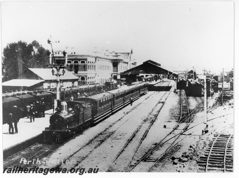 P20200
G class loco hauling a passenger train, station building, bracket signal overall roof, Perth, elevated view  looking west 
