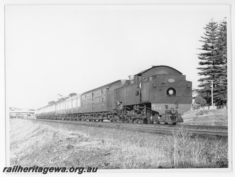 P20203
DD class 593, bunker first, on train of empty passenger coaches, overhead traffic bridge, west of Maylands, ER line, side and front view from trackside
