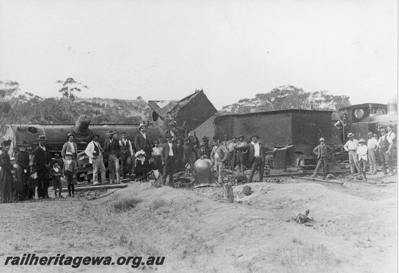 P20212
R class 148, wrecked by derailment of Perth Albany passenger train after collision with a bull, in which the fireman was tragically killed, onlookers, near Gilgering, GSR line, side on view from trackside
