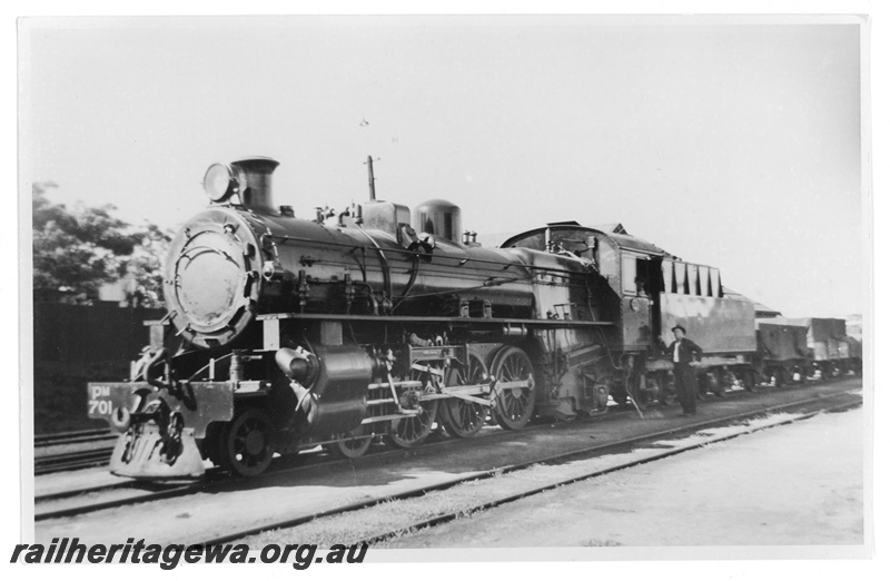 P20218
PM class 701. Front three-quarter view of left hand side, showing reservoir cylinder under running board and original Cardew cylinder relief valves mounted to side of smokebox. Mechanical lubricator shown in works photos has already been replaced. ER line
