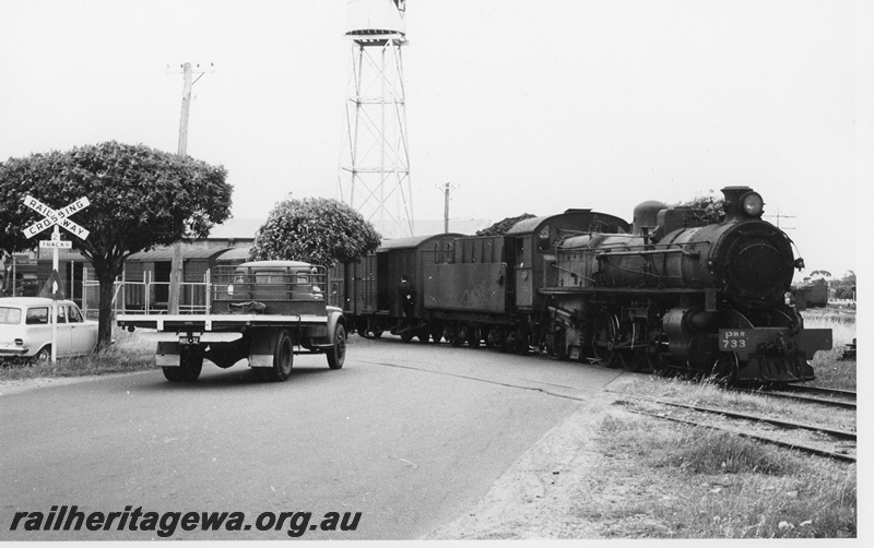 P20236
PMR class 733 shunting goods wagons across Whatley Crescent Maylands. The siding went into Massey Harris agricultural machinery factory. Elevated water tower is on factory property, not WAGR. ER line.
