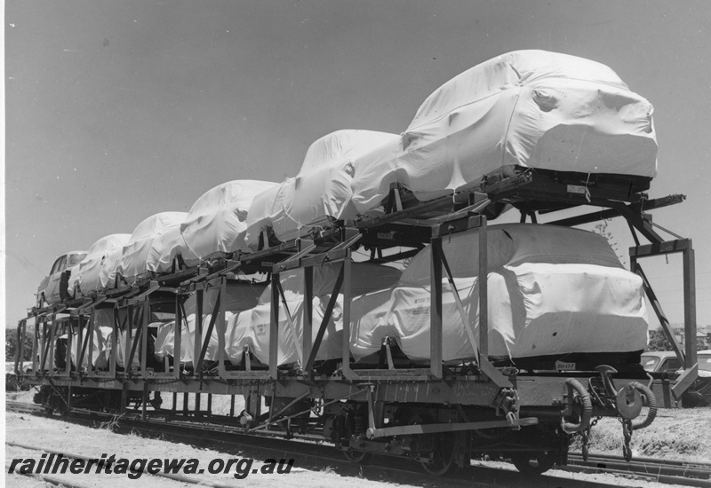 P20246
QMB class 20001 car carrying wagon. Photo shows Holden car bodies covered in tarpaulin on the wagon.  
