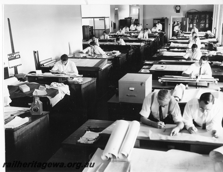 P20266
Interior of Drawing Office at Midland Workshops No 3 of 3, drawing boards, drawings, draughtsmen at work, clock, view from elevated position at front of office
