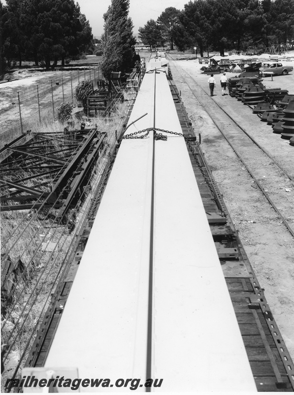 P20275
Transport of Vickers Hoskins gantry crane to Avon Yard No 4 of 4, crane components loaded onto multiple wagons, siding, workers, Midland, ER line, view from an elevated position looking along the length of the rake
