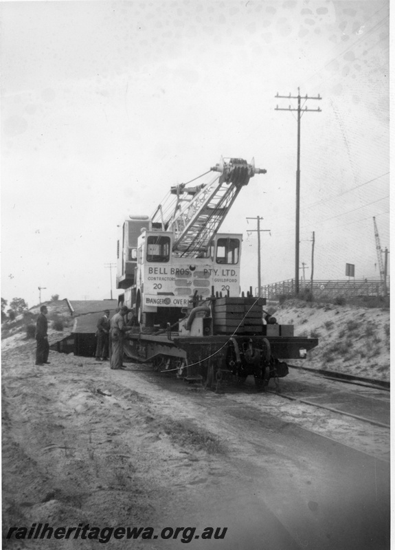 P20278
Goods despatch to the South West flood zone No 3 of 3, Bell Bros mobile crane, on board flat wagon, workers, Midland, ER line, side and end view 

