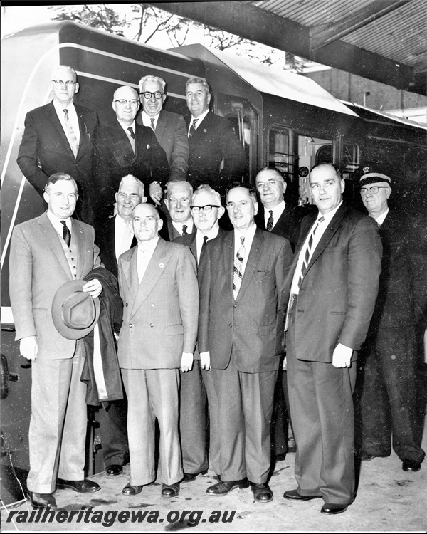 P20280
Group Photograph at the official inspection of A class 1502 at Perth Station : Top Row: Syd Griffiths C.M.E. , ?,  Chas Gates, Co-ordinator of S.G. Planning ((or Comptroller of Stores), Norm Turner, Comptroller of A.cs & Audit: Bottom Row: Chas Court, Minister for Railways, Arthur Moyle. Chief Traffic Manager, K.D. Reeves, Industrial & Staff Manager, Cedric Stewart, Chief Civil Engineer, Clem Robinson, Senior Administrator, Cecil Eivers, Secretary for Railways, C.G.C. Wayne, Commissioner of Railways, Ken McGowan, Commercial Manager, ? Station Master (Ref: Railways Institute Magazine, September 1960)
