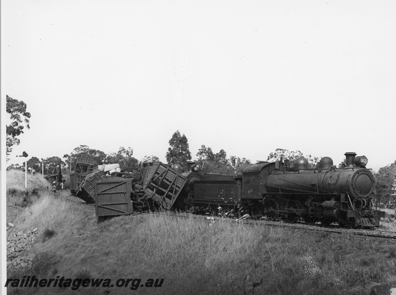 P20284
Derailment in the Darling Range. Locomotive L class 251, numerous wagons on side. ER line.
