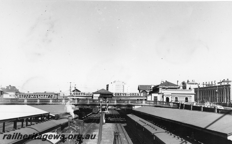 P20294
Perth Railway Station - a view looking east. Shows 3 passenger trains, K class hauling goods train and tram car on the Horseshoe Bridge. ER line.  
