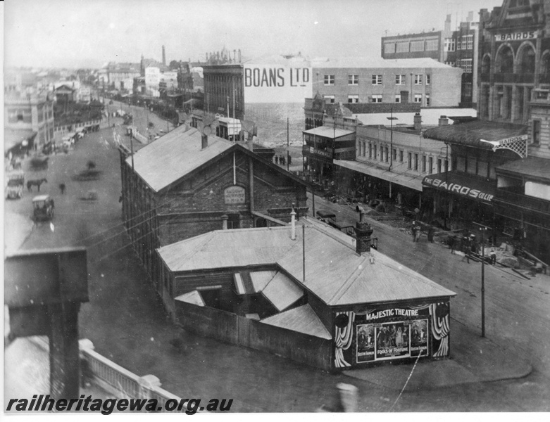 P20297
Perth Railway Station - photo taken from Horseshoe Bridge looking east  shows station entrance,  Boans and Baird's stores to the right . In foreground the building housed the Railway Institute. ER line. 
