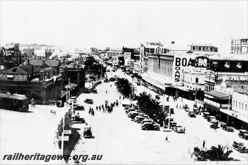 P20301
Perth city station, car park, palm trees, Wellington Street, Grand Central hotel, Boans store, horseshoe bridge with single truck saloon tram car, pedestrians, overview from elevated position
