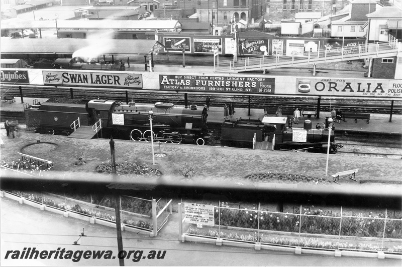 P20302
V class 1209, A class 11, on display at Perth station in Royal Show week, steam loco on passenger train, platforms, canopies, pedestrian ramp, overhead footbridge,  tracks, advertising signs, buildings on north side of station, view from elevated position
