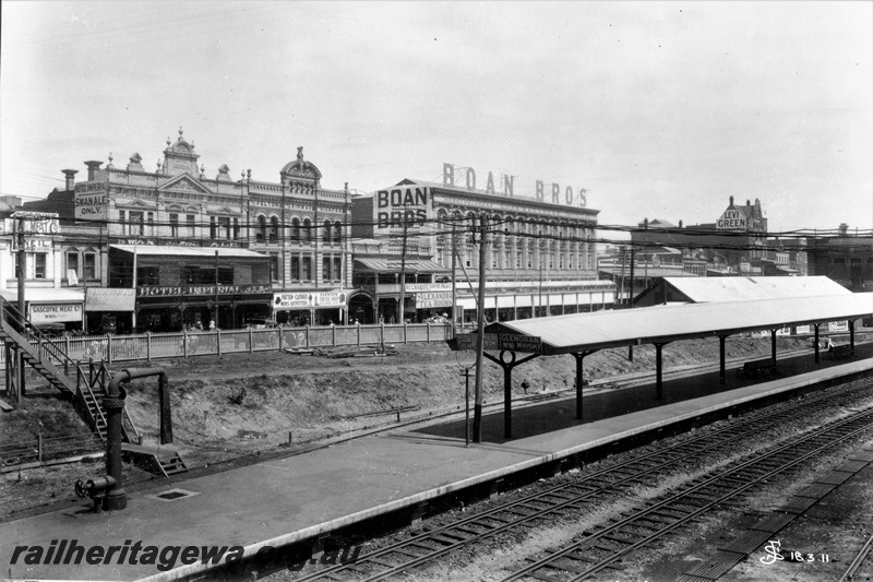 P20336
View across Perth station, looking south, water column, platform, canopy, tracks, commercial premises including Gascoyne Meat Co, Hotel Imperial, Patten Clothier, Everton Toffee Shop, Alexandra Tea Rooms, Rechabite Coffee Palace, Boan Bros, Levi Green, view form elevated position
