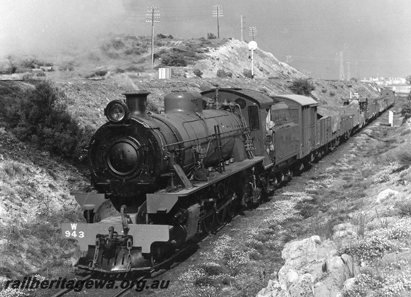 P20391
W class 943 hauling Down goods train leaving Leighton yard towards Cottesloe. Mixed goods train. Main line from Fremantle to Perth is behind train, on higher bank. ER line.
