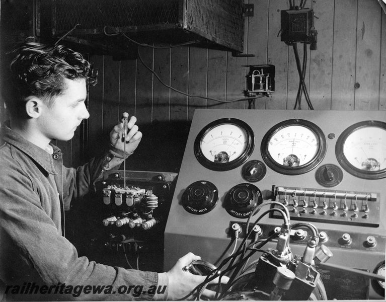 P20444
Apprentice electrical fitter, adjusting cut in / cut out relay for generator on test, electrical shop, Midland workshops, ER line, close up, interior view
