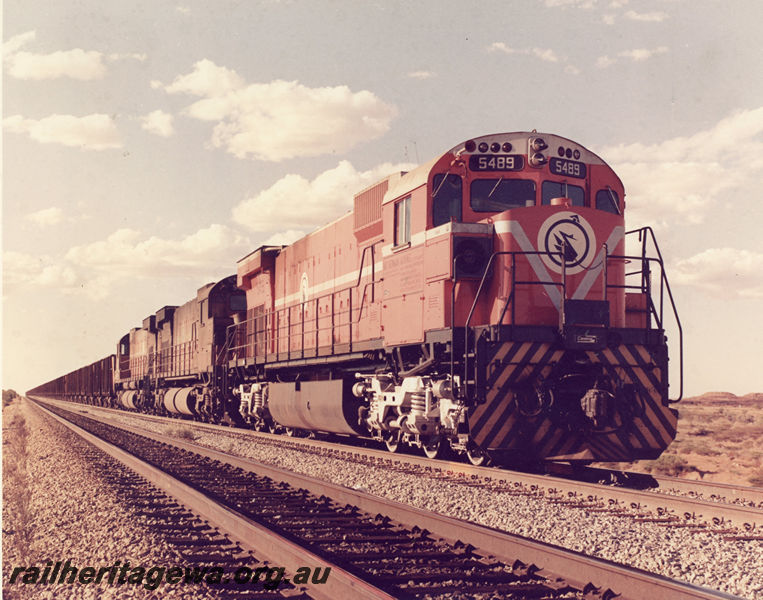 P20519
Mount Newman Mining diesel loco No 5489, with two other diesel locos, triple heading iron ore train, waiting in siding, side and front view 
