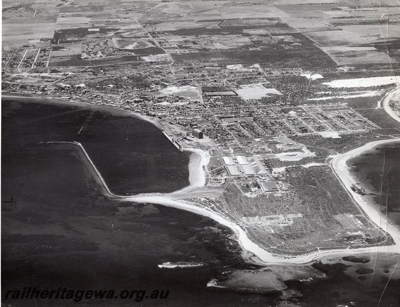 P20528
Port of Geraldton, harbour, breakwater, silos, sheds, houses, roads, NR line, aerial view
