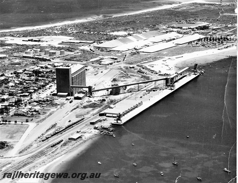 P20529
Harbour, beach, wharf, silos, conveyor, wheat bins, sheds, boats, houses, Geraldton, NR line, aerial view
