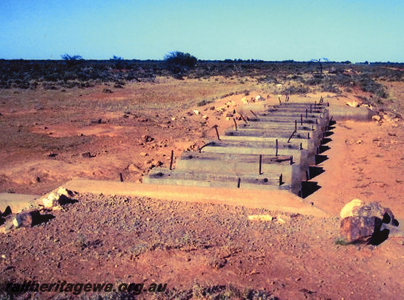 P20548
Concrete piers in dry watercourse in desolate country between Mullewa and Meekatharra, NR line, view from watercourse bank
