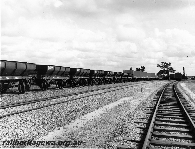 P20596
Standard gauge WSJ Class 4-wheel ballast hoppers (ex-Commonwealth Railways BAS Class), WSF Class flat wagons (ex-Commonwealth Railways R Class), WF Class flat wagon, narrow gauge wagons on adjacent roads, Millendon Junction, standard gauge construction project
