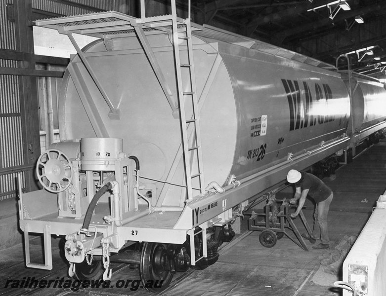 P20695
XW class 21326 wheat wagon, other narrow gauge wheat wagons, being unloaded inside shed by bottom discharge, worker, end and side view from trackside
